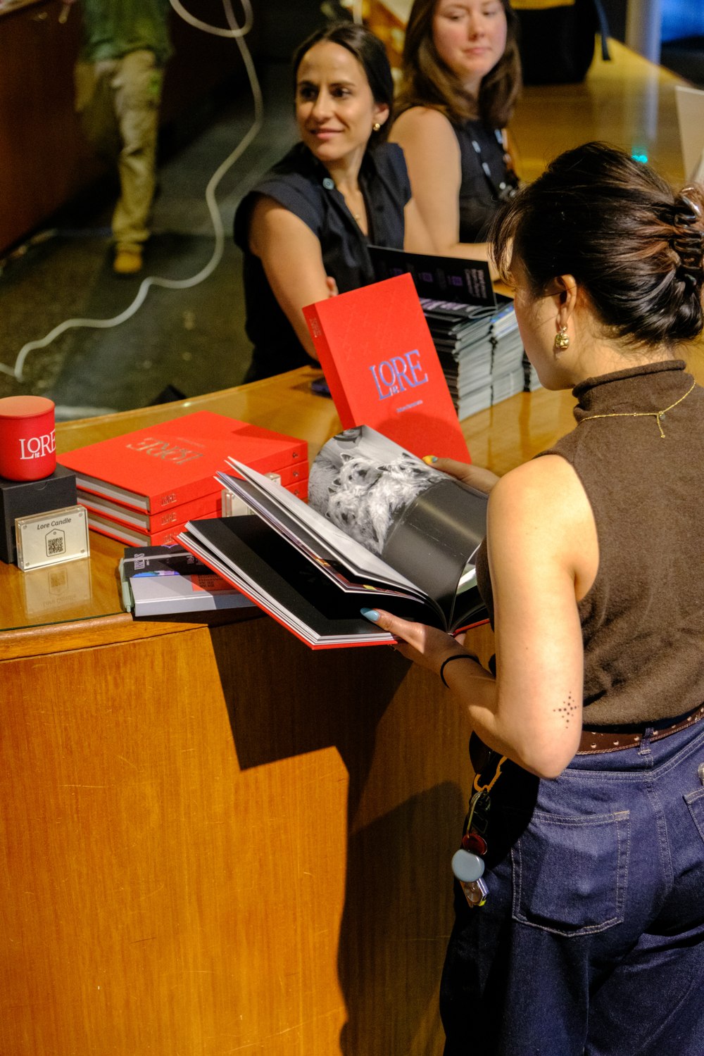 A VISIONS attendee explores a LORE journal at the Future Commerce bookshop